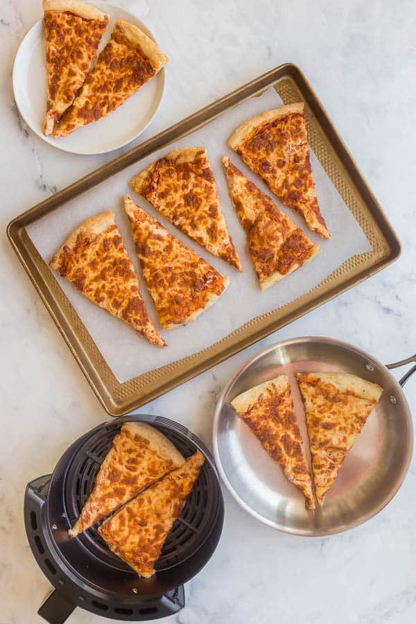 The best way to reheat pizza so that it is crispy on the bottom, with perfectly melted cheese! Never dry, never soggy! #pizza #dinner #recipes overhead image of different ways to reheat pizza