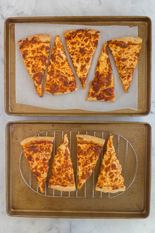 leftover pizza slices on baking sheet with rack and parchment