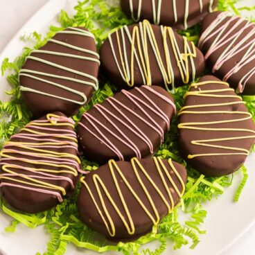 chocolate coated reeses easter eggs on white platter