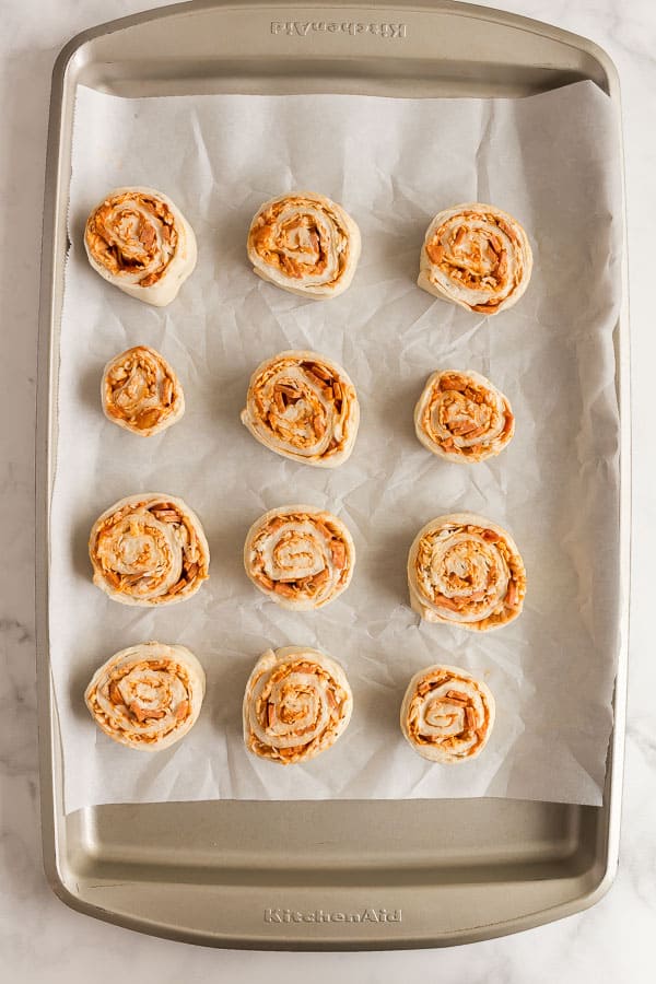 unbaked pizza rolls on baking sheet