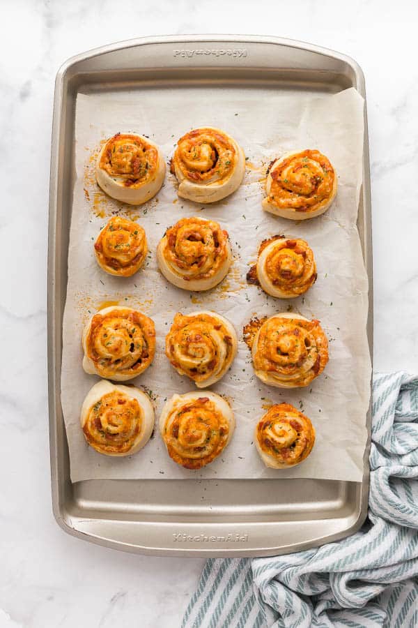 overhead image of baked pizza rolls on a sheet pan