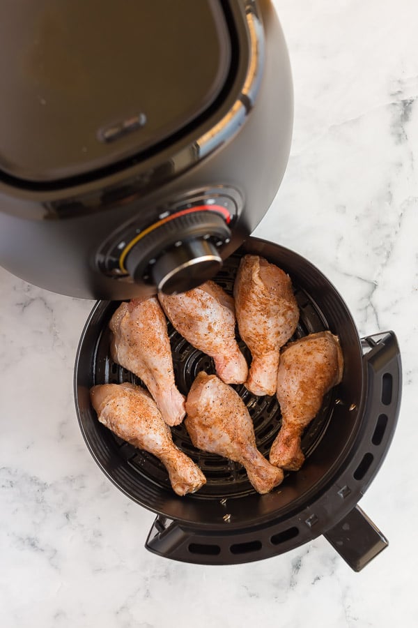 raw chicken legs going into air fryer