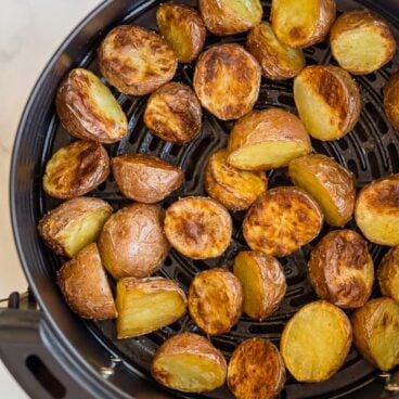 close up of cooked air fryer potatoes in basket