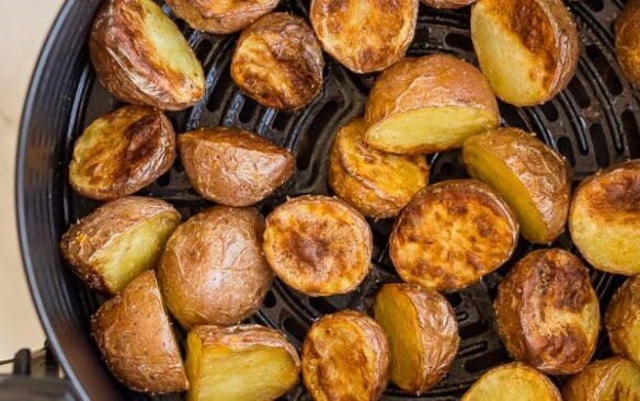 close up of cooked air fryer potatoes in basket