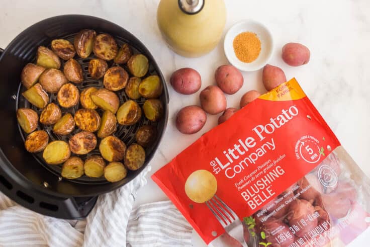 air fryer basket with potatoes and bag of Little potatoes