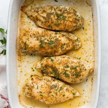 overhead image of baked chicken breasts in pan