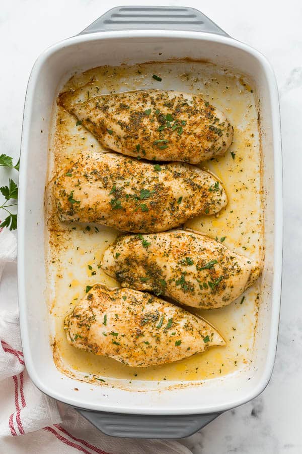 overhead image of baked chicken breasts in pan