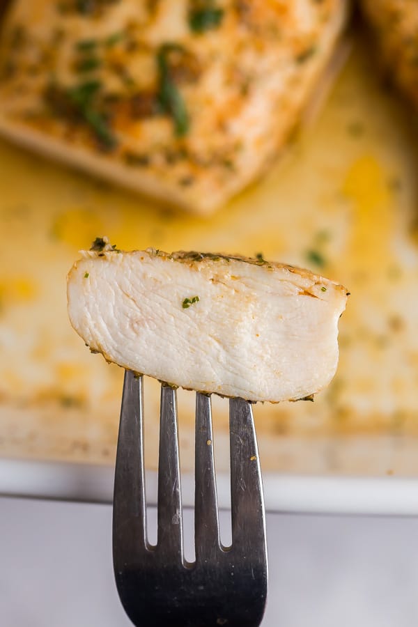 slice of baked chicken breast on fork