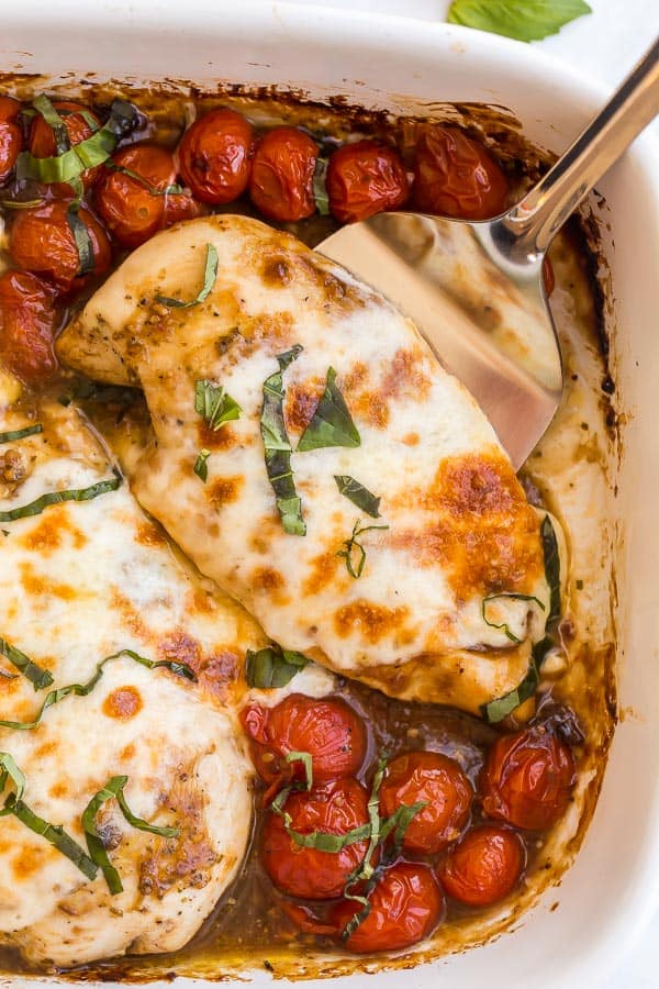 close up of caprese chicken in baking dish