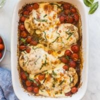 baked caprese chicken with mozzarella and topped with basil