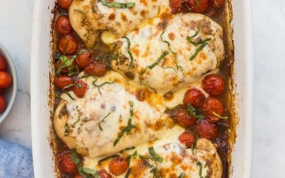 baked caprese chicken with mozzarella and topped with basil