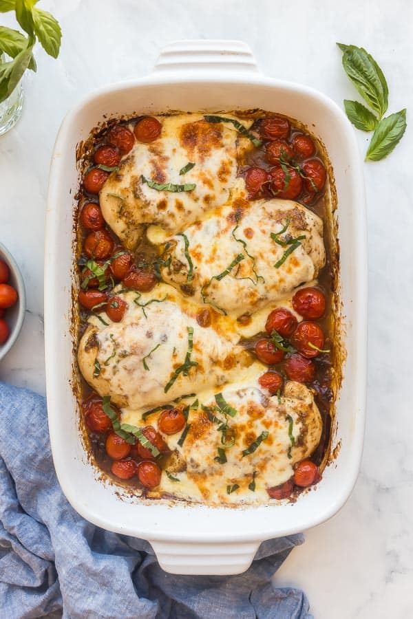 baked caprese chicken with mozzarella and topped with basil