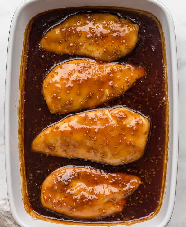 overhead image of honey garlic chicken breasts in baking dish