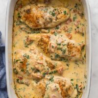 overhead image of tuscan chicken breasts in white baking dish