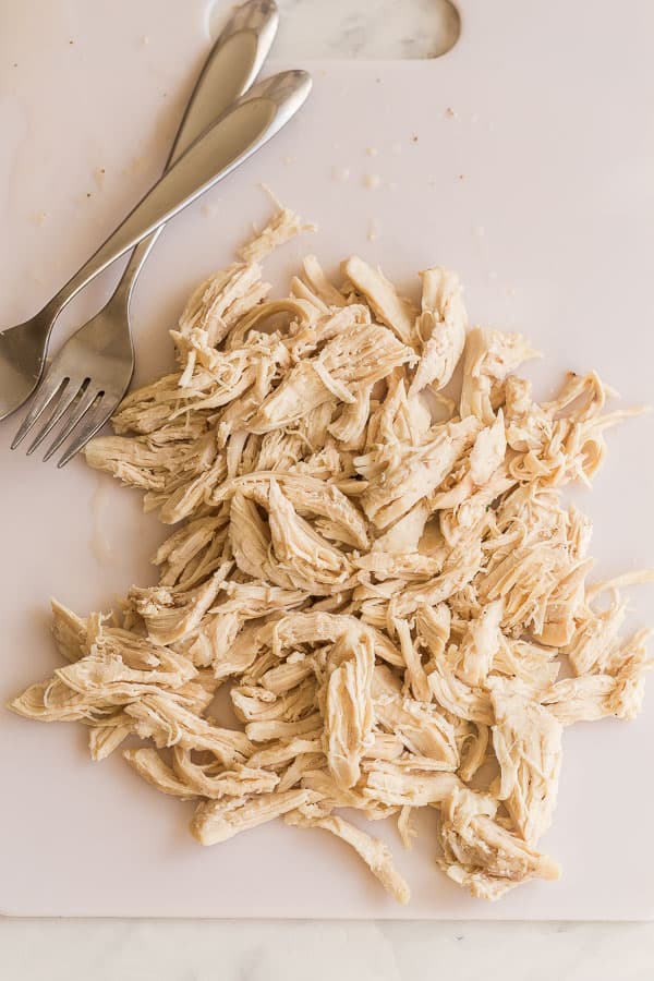 shredded chicken on cutting board