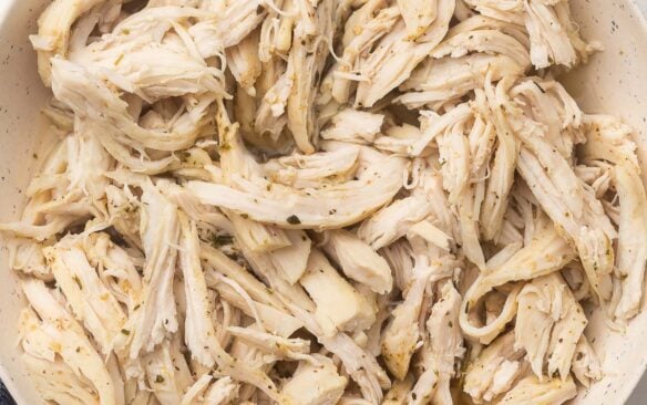 square image of instant pot shredded chicken in bowl.