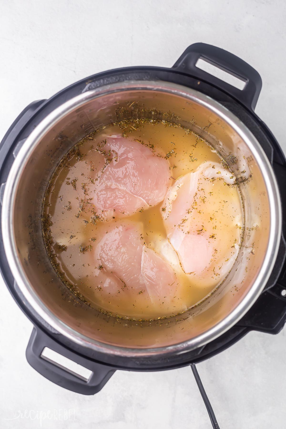 chicken breasts in instant pot in broth and seasoning.