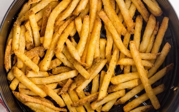 overhead image of french fries in air fryer