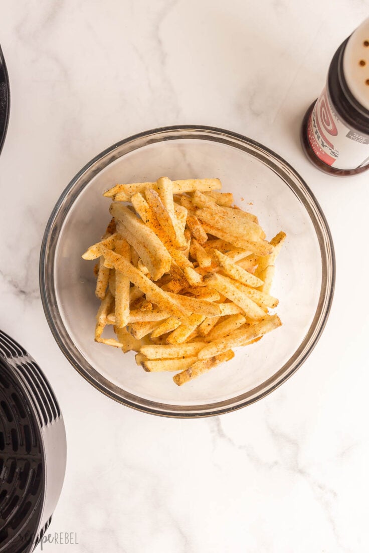 frozen french fries in bowl with seasoning