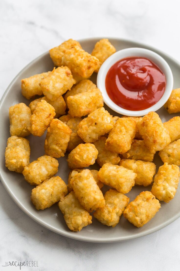 crispy air fryer tater tots on grey plate with ketchup