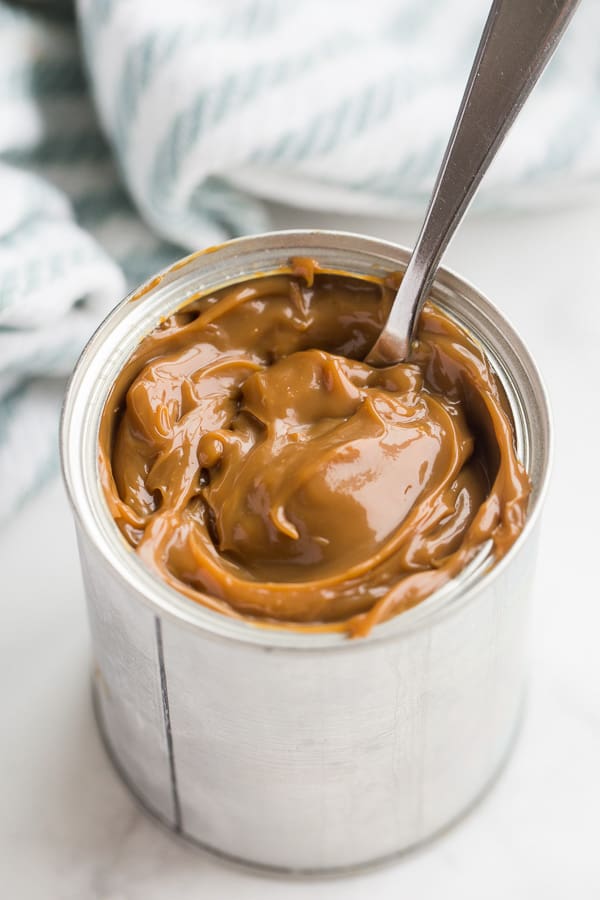 can of dulce de leche with spoon in it