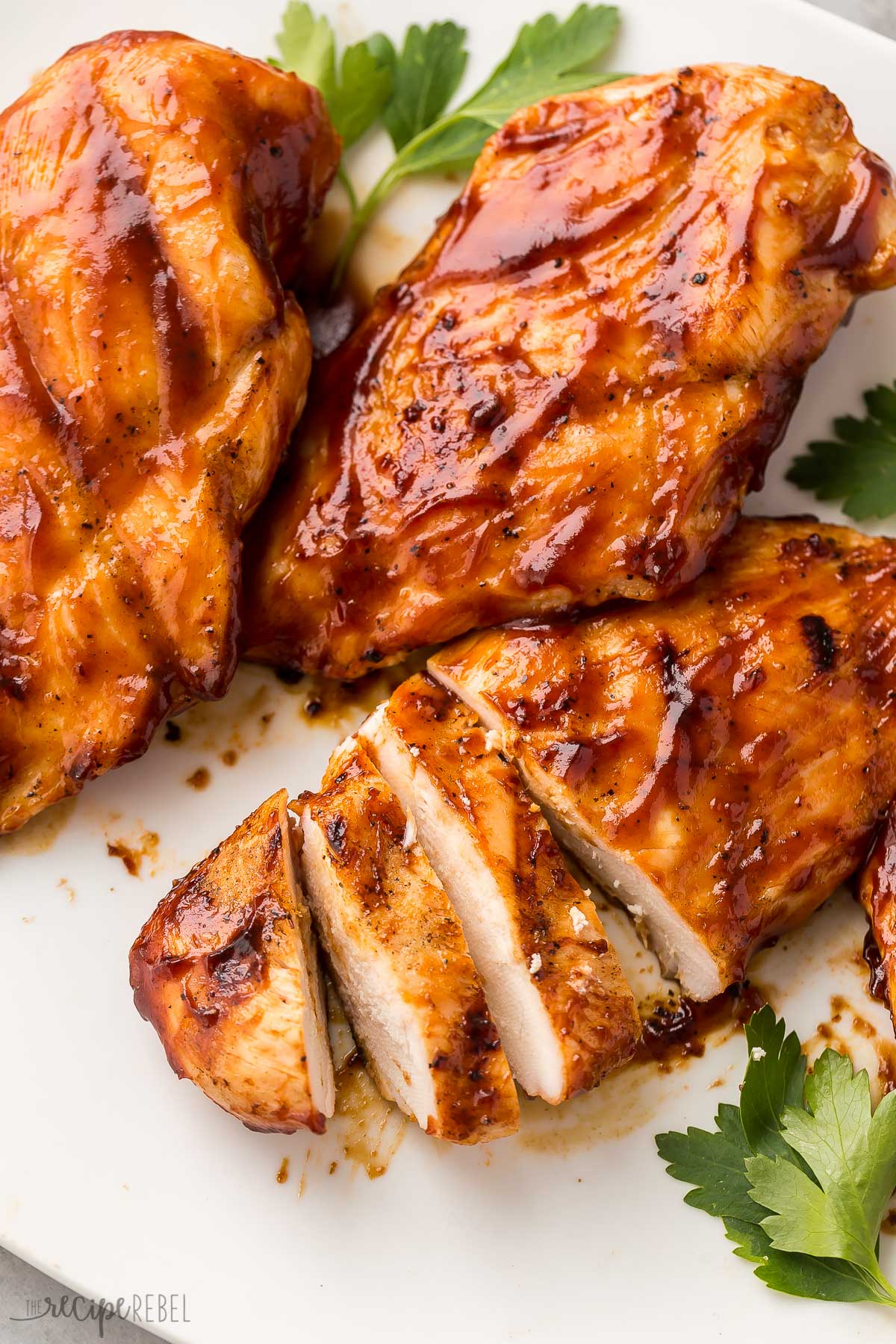 sliced bbq chicken breast on white plate