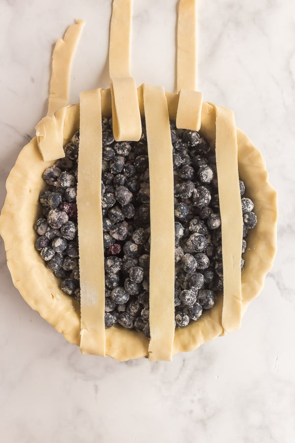 alternating strips of lattice pie crust lifted up