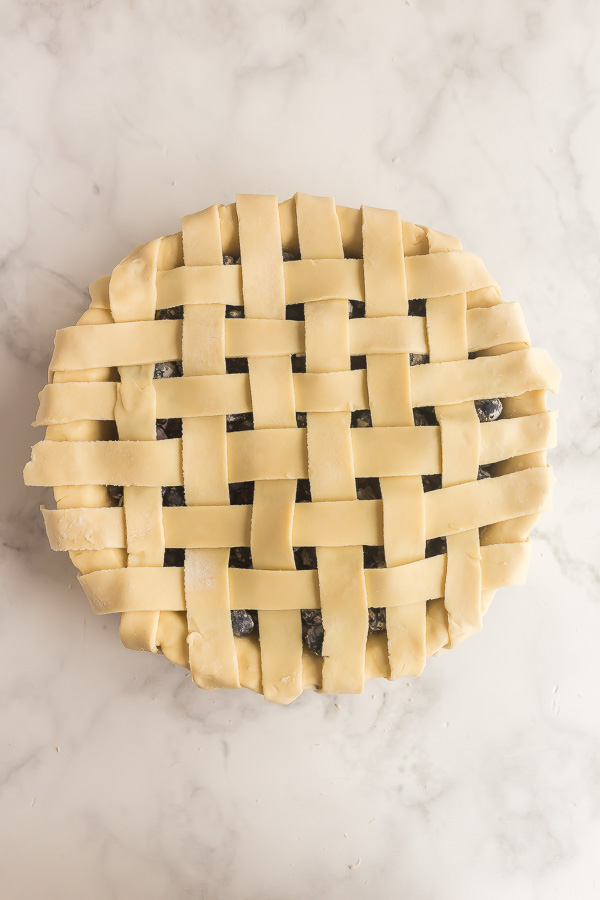 overhead image of blueberry pie with lattice pie crust uncooked