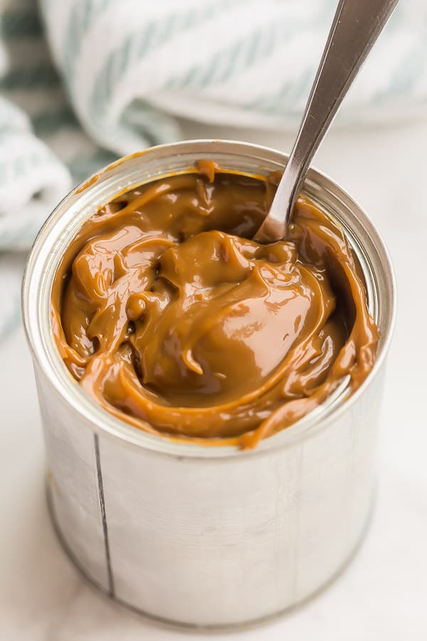 dulce de leche in can with spoon stuck in