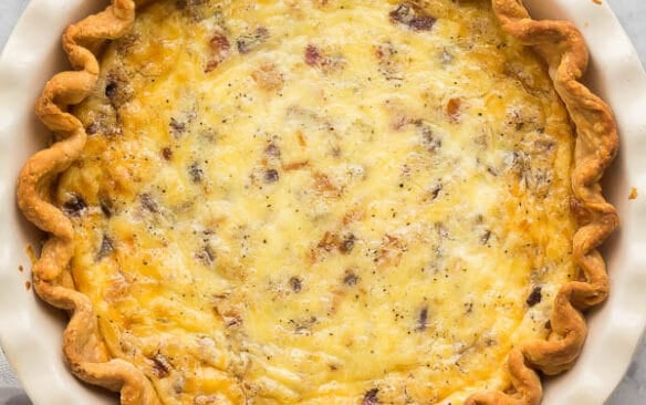 overhead image of quiche lorraine on marble background