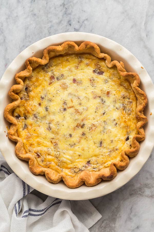 overhead image of quiche lorraine on marble background