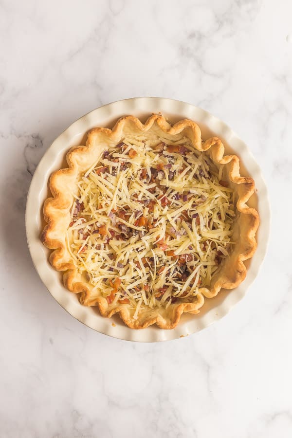 blind baked pie crust with bacon onions and cheese in it