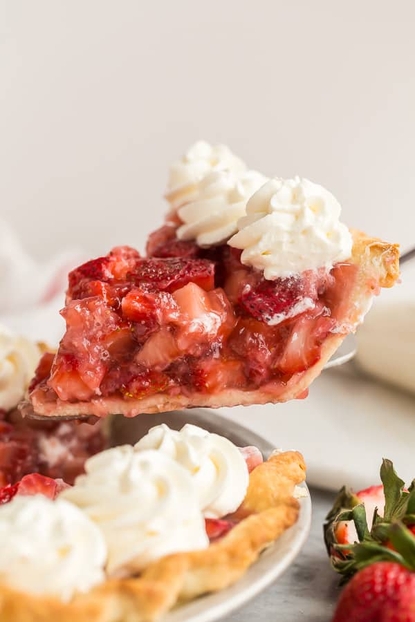 slice of strawberry pie being lifted out of whole pie