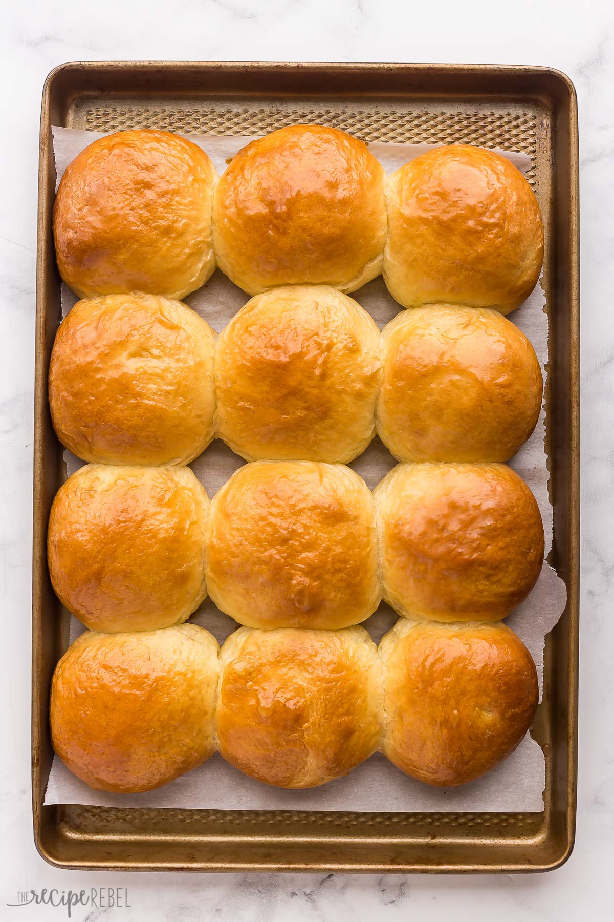 overhead image of brioche buns on baking sheet