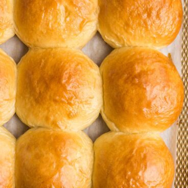 close up image of brioche buns on baking sheet