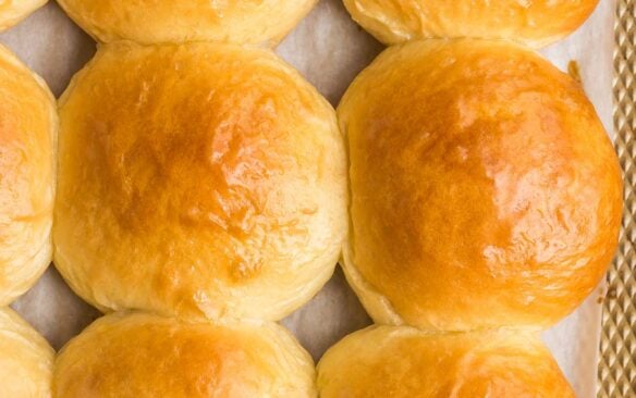 close up image of brioche buns on baking sheet