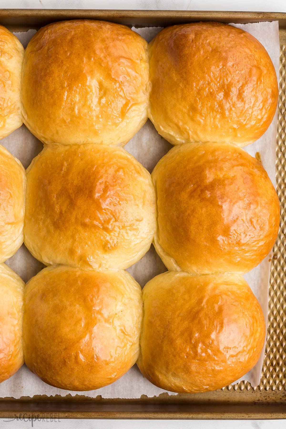 close up image of brioche buns on baking sheet