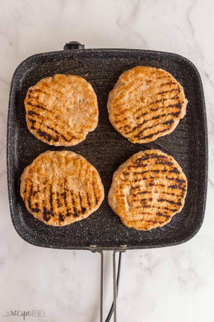 cooked chicken burgers on grill pan