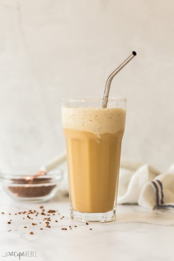 tall glass of blended frappe with instant coffee in the background