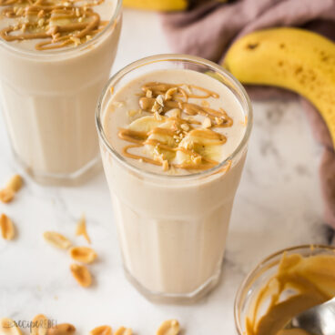 close up image of peanut butter banana smoothie in glass