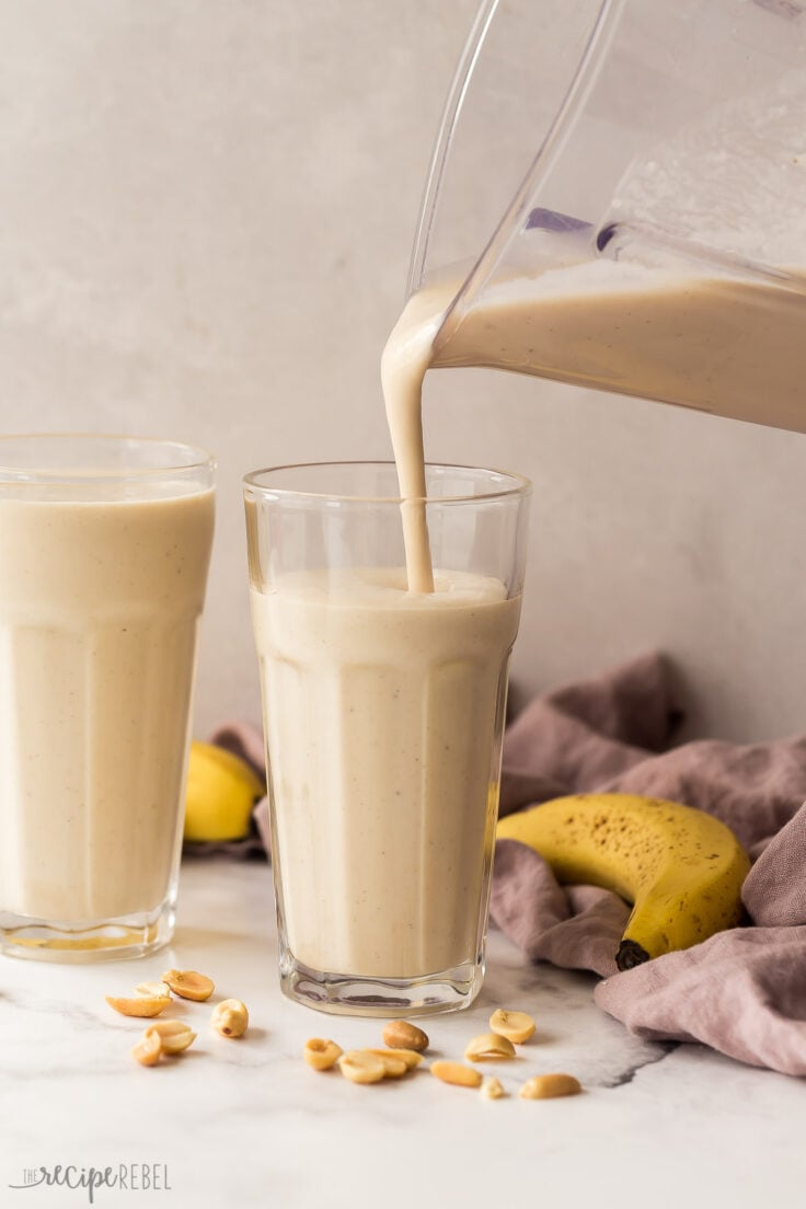 pouring peanut butter banana smoothie into glasses from blender