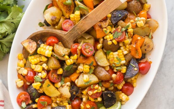 square image of southwest potato salad with wooden spoon stuck in