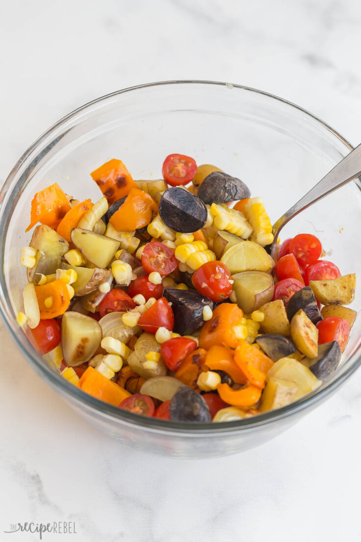 roasted vegetables stirred together in glass bowl