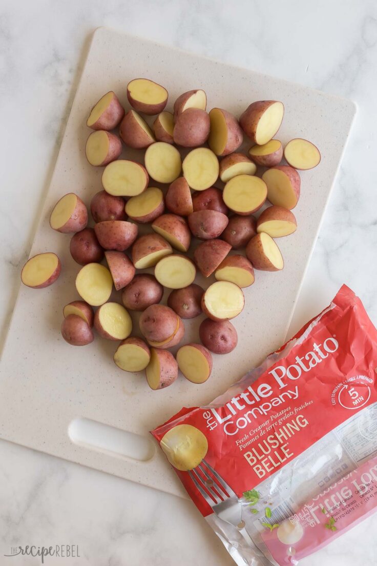 bag of Little potatoes with halved potatoes on cutting board