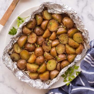 overhead image of grilled potatoes in foil