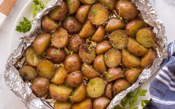 overhead image of grilled potatoes in foil