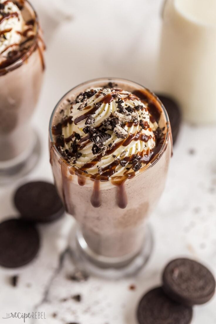 close up image of whipped cream chocolate sauce and crushed Oreos on milkshake