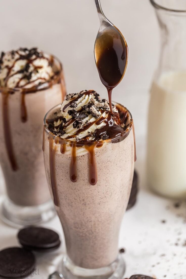 close up image of chocolate sauce being drizzled on milkshake