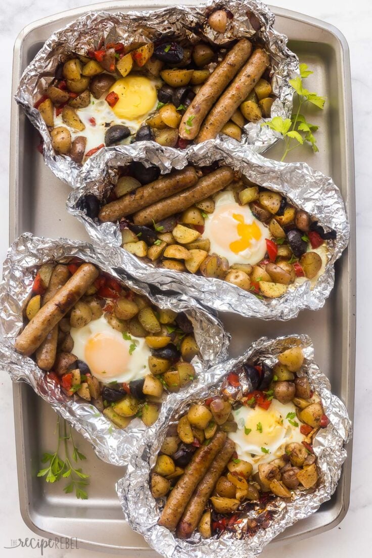 four foil pack breakfasts lined up on sheet pan