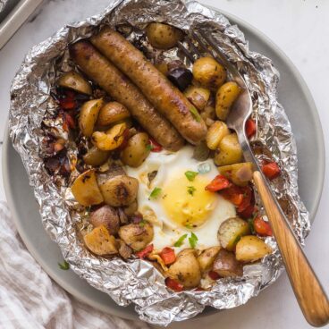 overhead image of breakfast foil pack on plate with fork